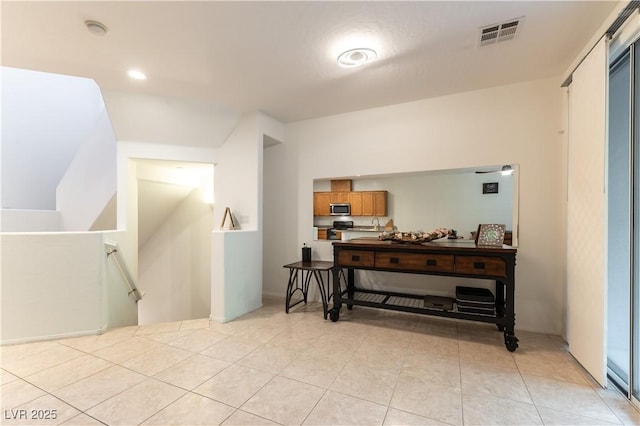 9986 Sand Key St, Las Vegas, NV 89178 - hallway with an upstairs landing, light tile patterned flooring, a sink, and recessed lighting