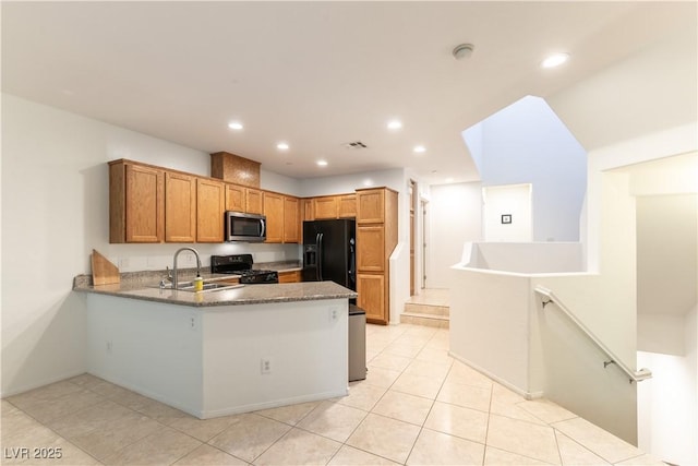 9986 Sand Key St, Las Vegas, NV 89178 - kitchen with black appliances, a sink, a peninsula, light tile patterned flooring, and recessed lighting