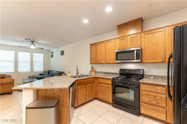 9986 Sand Key St, Las Vegas, NV 89178 - kitchen with black appliances, light tile patterned flooring, a peninsula, a sink, and open floor plan