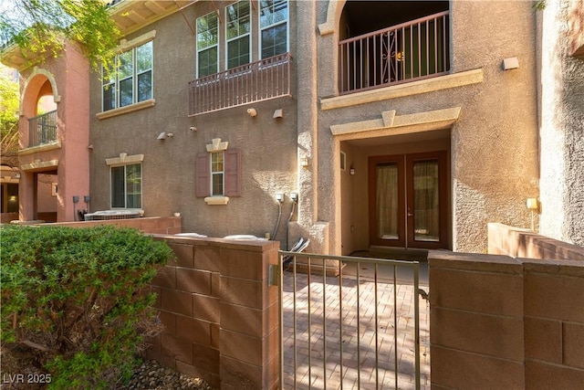 9986 Sand Key St, Las Vegas, NV 89178 - doorway to property featuring french doors, stucco siding, fence, and a balcony