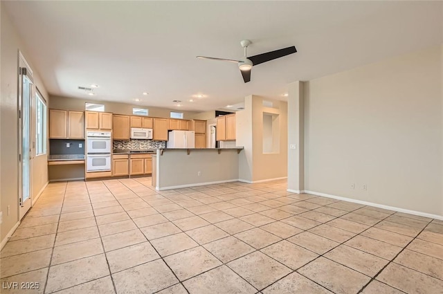 10212 Donald Weese Ct, Las Vegas, NV 89129 - kitchen featuring white appliances, light tile patterned floors, light brown cabinetry, a peninsula, and ceiling fan