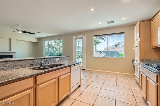 10212 Donald Weese Ct, Las Vegas, NV 89129 - kitchen featuring a sink, white appliances, ceiling fan, dark stone counters, and light tile patterned floors