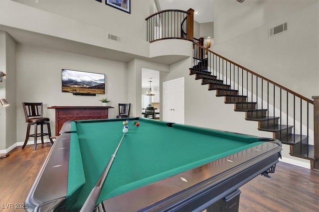 playroom with a towering ceiling, billiards table, wood finished floors, and baseboards
