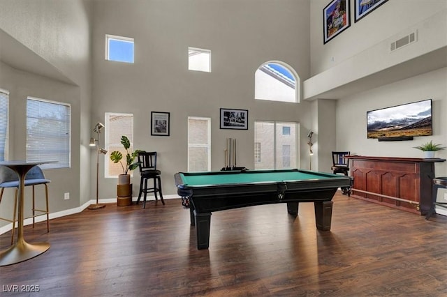 game room featuring a towering ceiling, wood finished floors, plenty of natural light, billiards, and baseboards