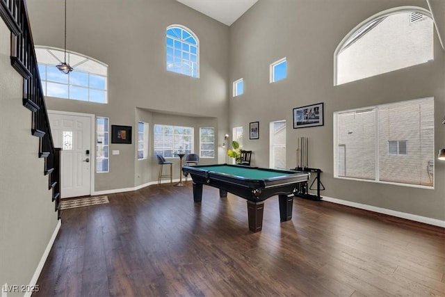 recreation room with billiards, baseboards, hardwood / wood-style flooring, and a high ceiling