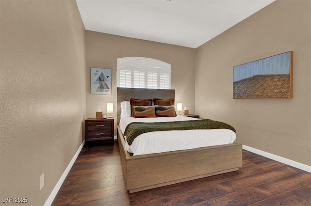 bedroom featuring baseboards and wood finished floors