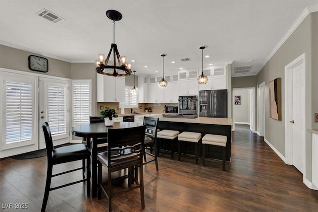 dining space featuring crown molding, dark wood-style flooring, a chandelier, recessed lighting, and baseboards