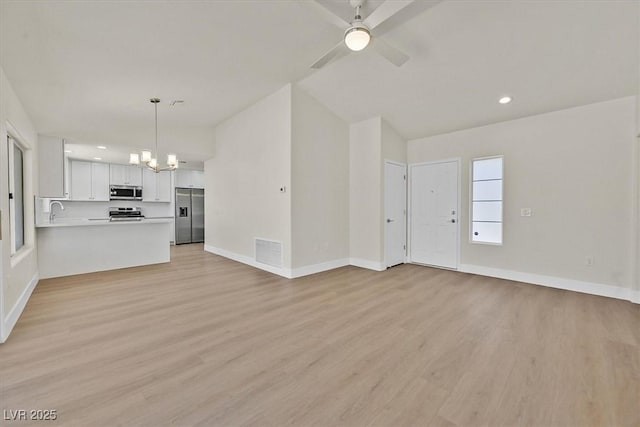 9552 Gold Bank Dr, Las Vegas, NV 89134 - unfurnished living room with light wood finished floors, a chandelier, recessed lighting, a ceiling fan, and vaulted ceiling