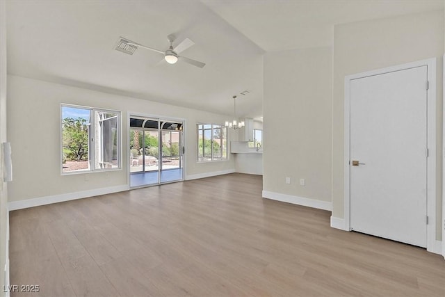 9552 Gold Bank Dr, Las Vegas, NV 89134 - unfurnished living room with a ceiling fan, a chandelier, wood finished floors, healthy amount of natural light, and vaulted ceiling