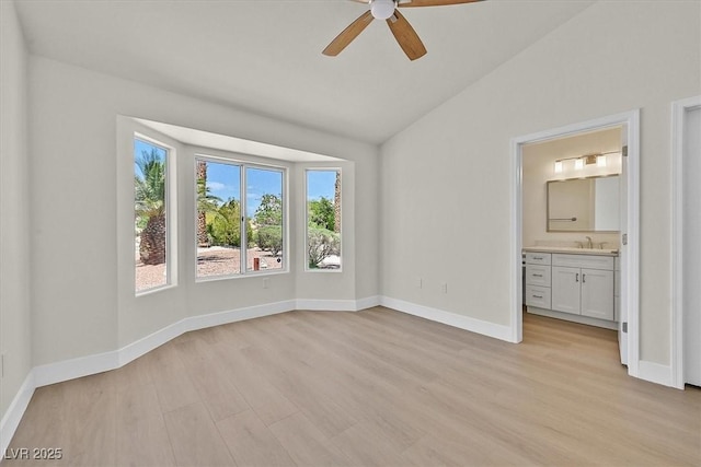 9552 Gold Bank Dr, Las Vegas, NV 89134 - unfurnished bedroom featuring vaulted ceiling, light wood-style flooring, ensuite bath, and ceiling fan