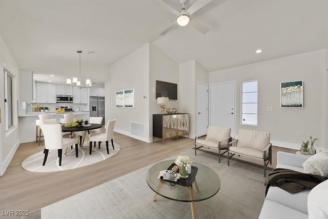9552 Gold Bank Dr, Las Vegas, NV 89134 - living room featuring light wood-type flooring, a chandelier, lofted ceiling, recessed lighting, and ceiling fan