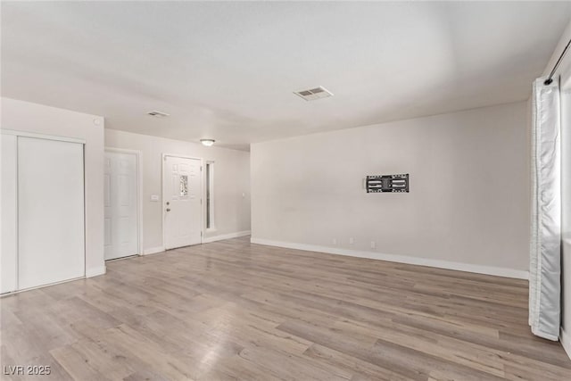 unfurnished room with wood finished floors and baseboards