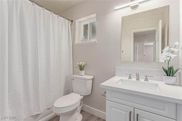 full bath with toilet, wood finished floors, vanity, baseboards, and shower / bathtub combination with curtain