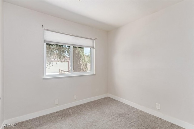 empty room featuring carpet flooring and baseboards