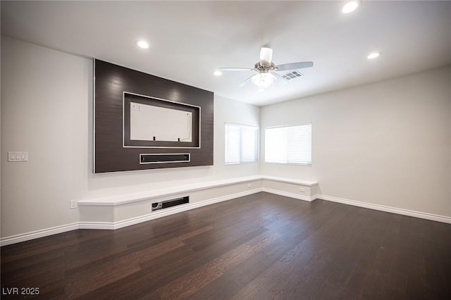 empty room featuring a ceiling fan, dark wood finished floors, baseboards, and recessed lighting