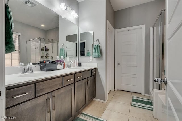 253 Kindly Way, Henderson, NV 89011 - bathroom with an enclosed shower, double vanity, tile patterned floors, a tub, and baseboards