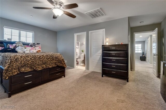 253 Kindly Way, Henderson, NV 89011 - bedroom featuring light colored carpet, ensuite bath, a ceiling fan, and baseboards