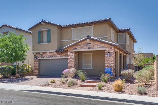 253 Kindly Way, Henderson, NV 89011 - view of front of house with stone siding, stucco siding, an attached garage, driveway, and a tile roof