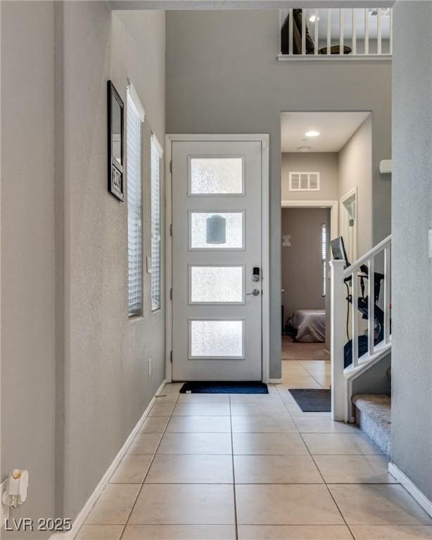 253 Kindly Way, Henderson, NV 89011 - entrance foyer with plenty of natural light, stairs, light tile patterned floors, and baseboards