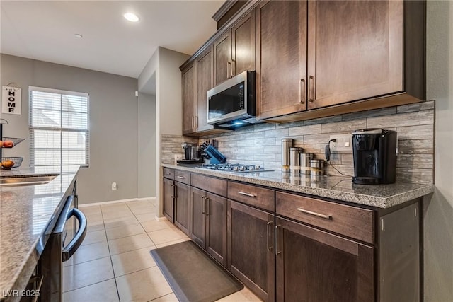 253 Kindly Way, Henderson, NV 89011 - kitchen featuring appliances with stainless steel finishes, tasteful backsplash, light tile patterned floors, a sink, and dark brown cabinets