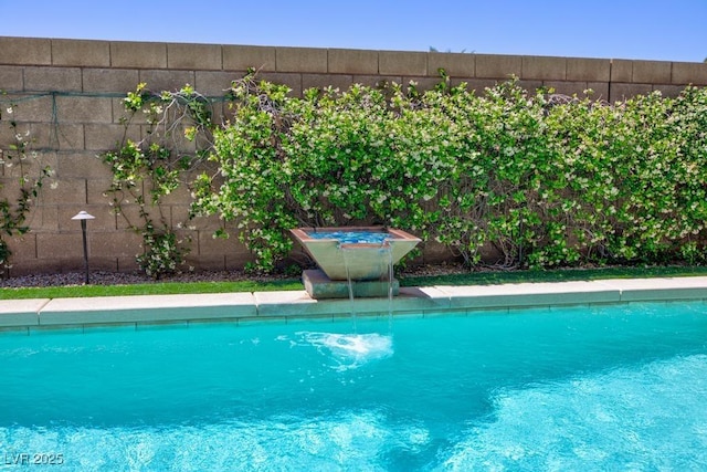 view of pool with fence