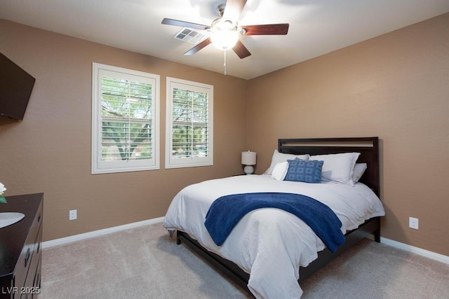 carpeted bedroom with baseboards and a ceiling fan