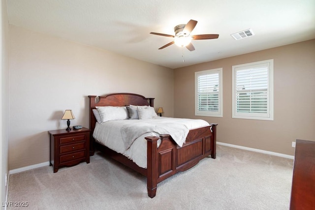 bedroom featuring light carpet, baseboards, and ceiling fan