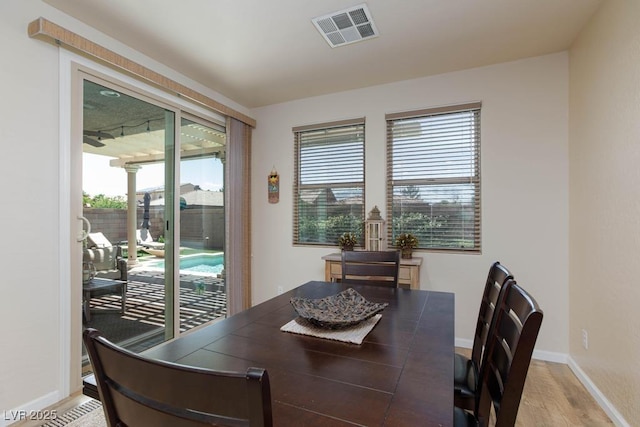 dining room with light wood finished floors and baseboards