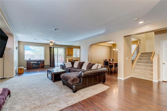 3440 Bella Viera Ct, Las Vegas, NV 89141 - living room with arched walkways, stairs, wood finished floors, baseboards, and recessed lighting