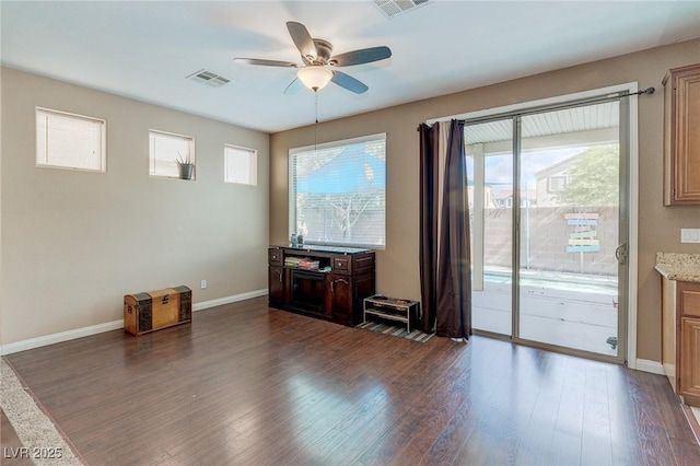 3440 Bella Viera Ct, Las Vegas, NV 89141 - unfurnished living room featuring a ceiling fan, dark wood-type flooring, and baseboards