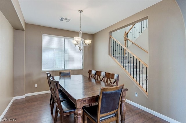 3440 Bella Viera Ct, Las Vegas, NV 89141 - dining area featuring wood finished floors, a chandelier, baseboards, and stairs