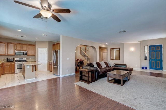 3440 Bella Viera Ct, Las Vegas, NV 89141 - living area with arched walkways, light wood-type flooring, ceiling fan, baseboards, and recessed lighting