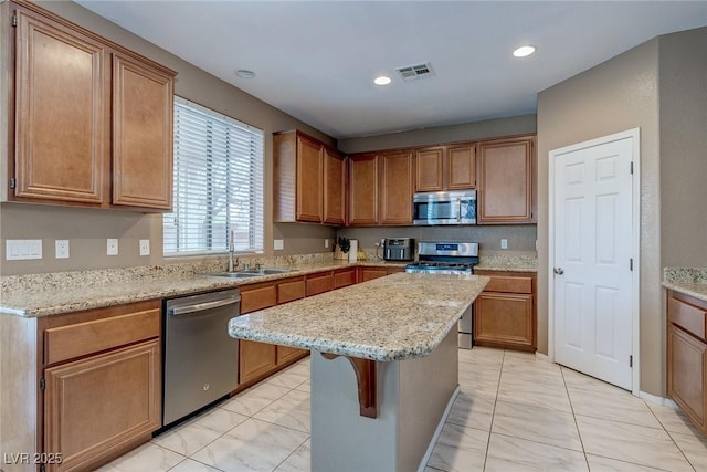 3440 Bella Viera Ct, Las Vegas, NV 89141 - kitchen featuring stainless steel appliances, a sink, light marble finish floors, a center island, and recessed lighting