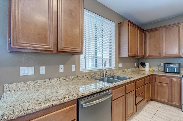 3440 Bella Viera Ct, Las Vegas, NV 89141 - kitchen featuring dishwasher, a sink, brown cabinets, and light stone countertops