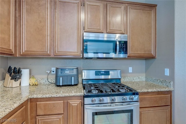 3440 Bella Viera Ct, Las Vegas, NV 89141 - kitchen with stainless steel appliances and light stone counters