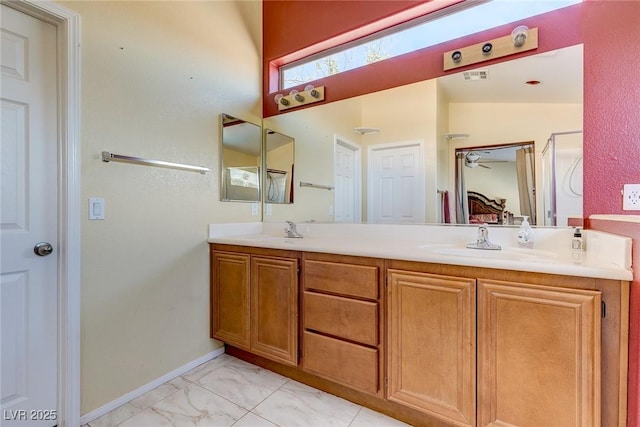 3440 Bella Viera Ct, Las Vegas, NV 89141 - full bathroom with marble look tiles, double vanity, connected bathroom, and baseboards