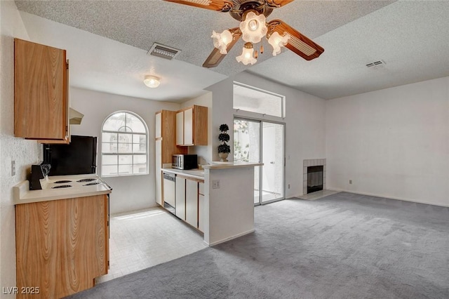 kitchen featuring dishwasher, stainless steel microwave, fridge, a ceiling fan, and light carpet