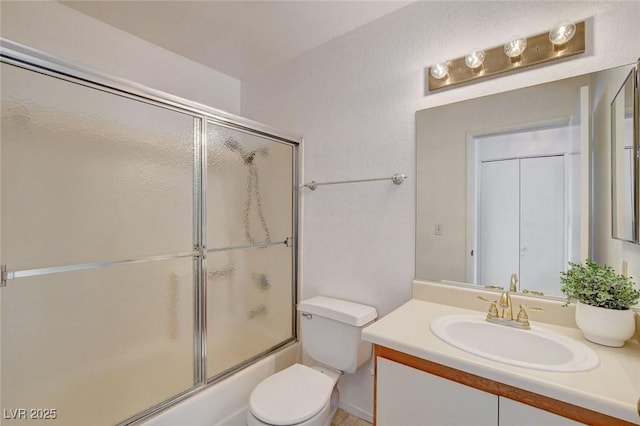 full bath with vanity, toilet, and enclosed tub / shower combo