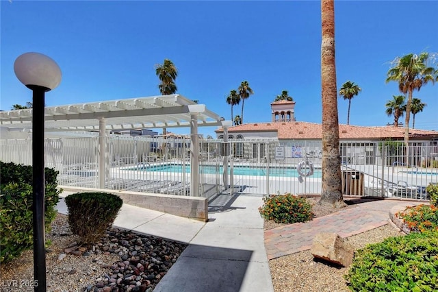 community pool with fence, a pergola, and a patio area