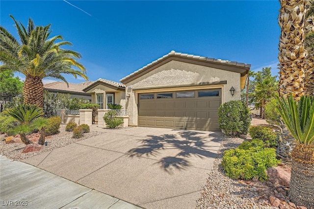 4552 Largo Cantata St, Las Vegas, NV 89135 - view of front of home featuring driveway, stucco siding, a garage, and a tile roof