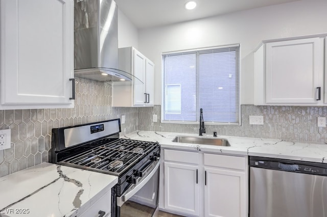 7849 Montour Falls St, Las Vegas, NV 89149 - kitchen with appliances with stainless steel finishes, wall chimney exhaust hood, a sink, white cabinets, and recessed lighting