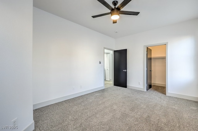 7849 Montour Falls St, Las Vegas, NV 89149 - unfurnished bedroom featuring light carpet, a walk in closet, baseboards, and ceiling fan