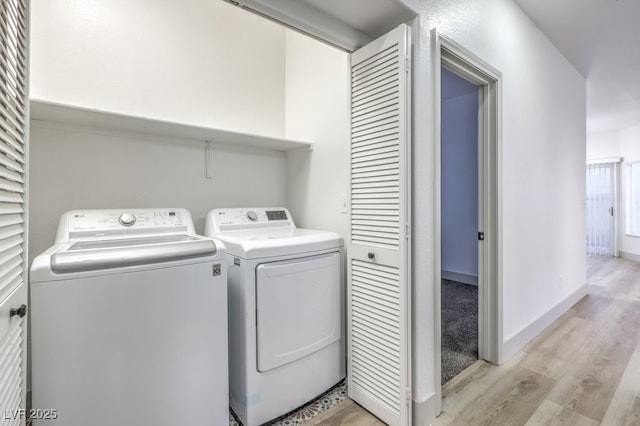 7849 Montour Falls St, Las Vegas, NV 89149 - laundry area featuring light wood finished floors, washing machine and clothes dryer, and baseboards