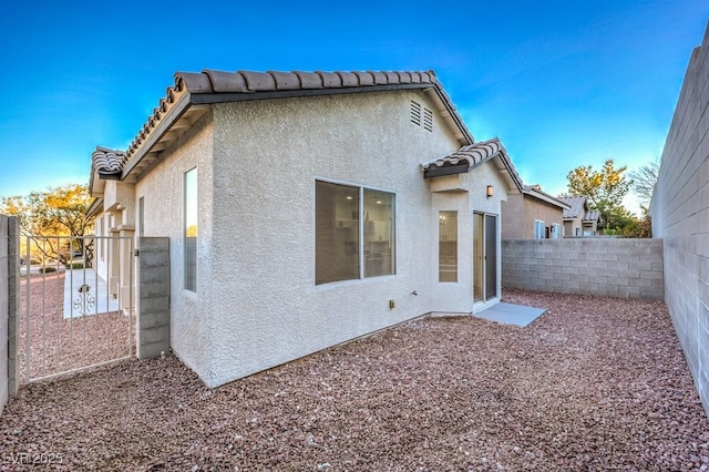 7849 Montour Falls St, Las Vegas, NV 89149 - back of house with stucco siding, a tile roof, and a fenced backyard