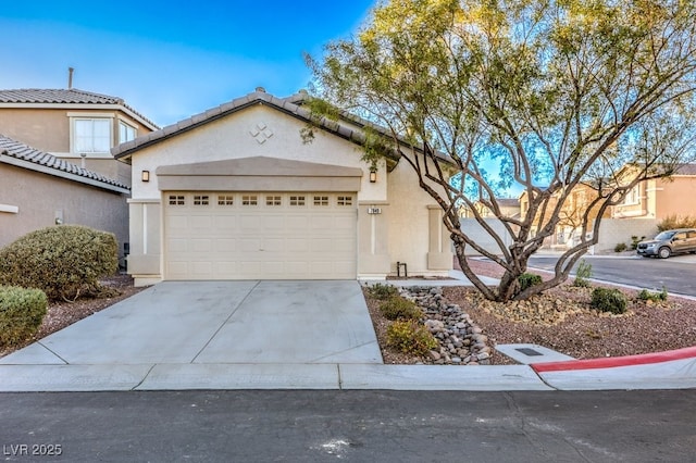 7849 Montour Falls St, Las Vegas, NV 89149 - view of front of home with driveway, an attached garage, and stucco siding