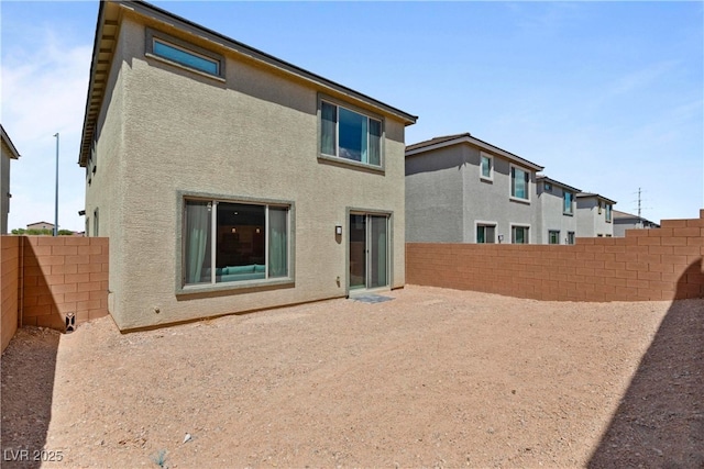 back of property featuring stucco siding, a fenced backyard, and a patio