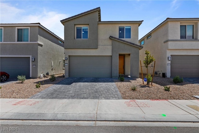 5937 W Frias Ave, Las Vegas, NV 89141 - contemporary home with an attached garage, stucco siding, and decorative driveway