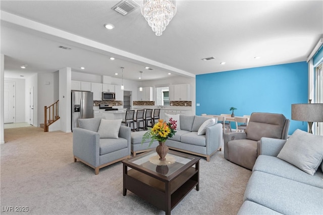 living room with recessed lighting, a chandelier, light colored carpet, and stairway