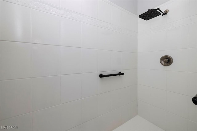 bathroom with tiled shower
