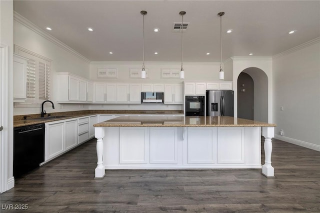 kitchen with black appliances, a sink, arched walkways, a spacious island, and white cabinets